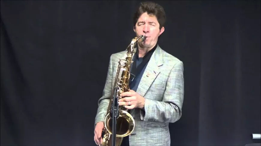john-hughes-sax-performer.webp